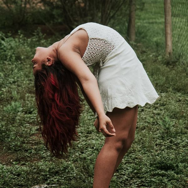 Person in a dynamic yoga flow pose, emphasizing movement and flexibility.